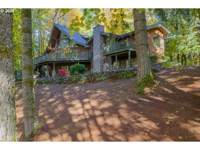 a aerial view of house with yard and mountain in the background