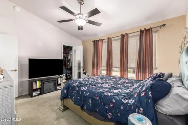 a bedroom with a bed and a flat screen tv