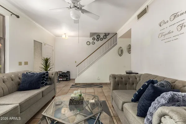 a living room with furniture and wooden floor