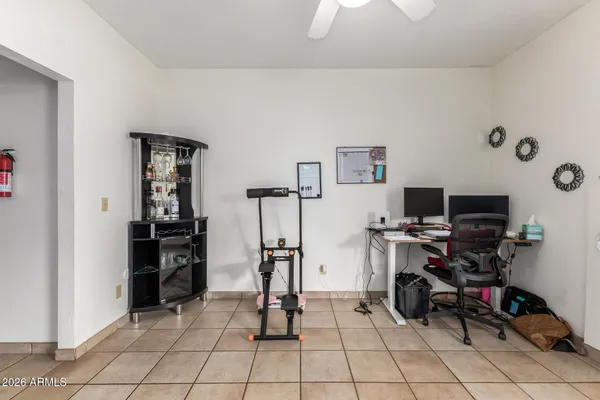 a view of a workspace with furniture and a window