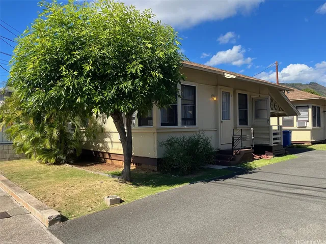 a front view of a house with garden