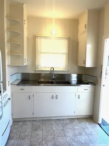 a kitchen with a sink window and cabinets