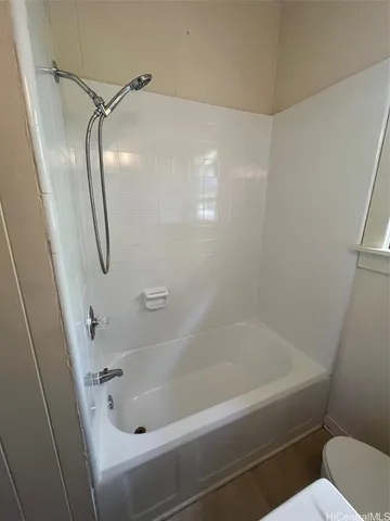 a bathroom with a tub and a shower