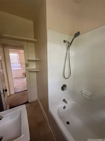 a bathroom with a bathtub and shower