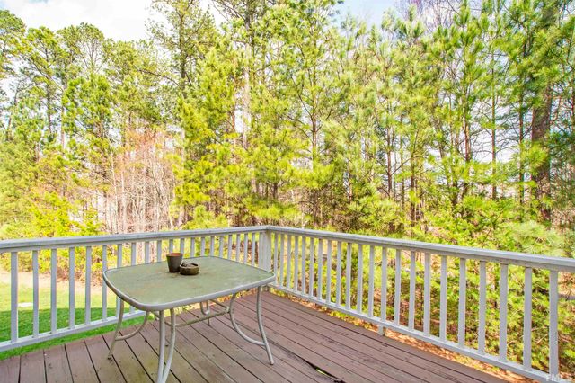 a view of a balcony with table and chairs