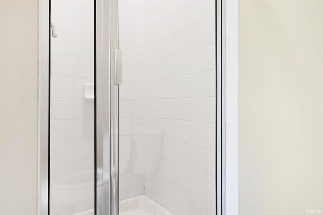 a bathroom with a glass shower door