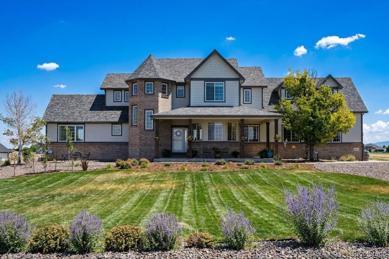 724 Imboden Road Watkins, CO 80137 - Photo 1 of 50 a front view of a house with a yard