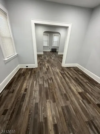 a view of a room with wooden floor and a sink