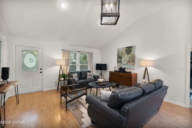 a living room with furniture and a wooden floor