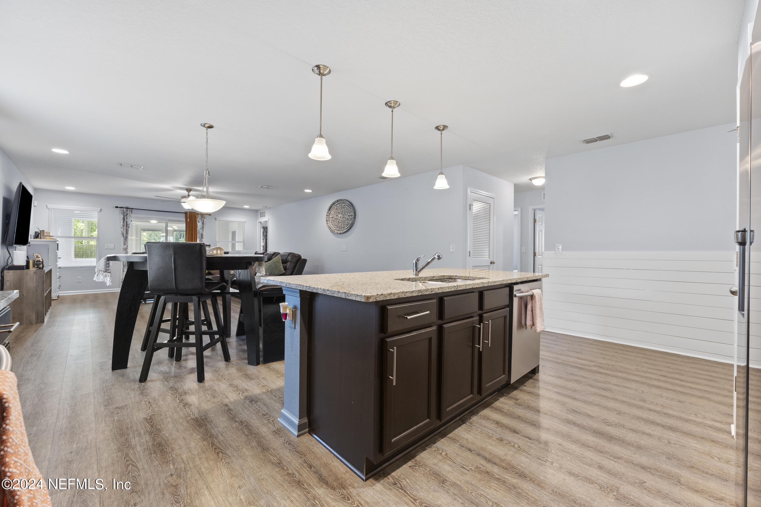 4021 Spring Glen Road Jacksonville, FL 32207 - Photo 8 of 39 a kitchen with a wooden floor and a view of living room