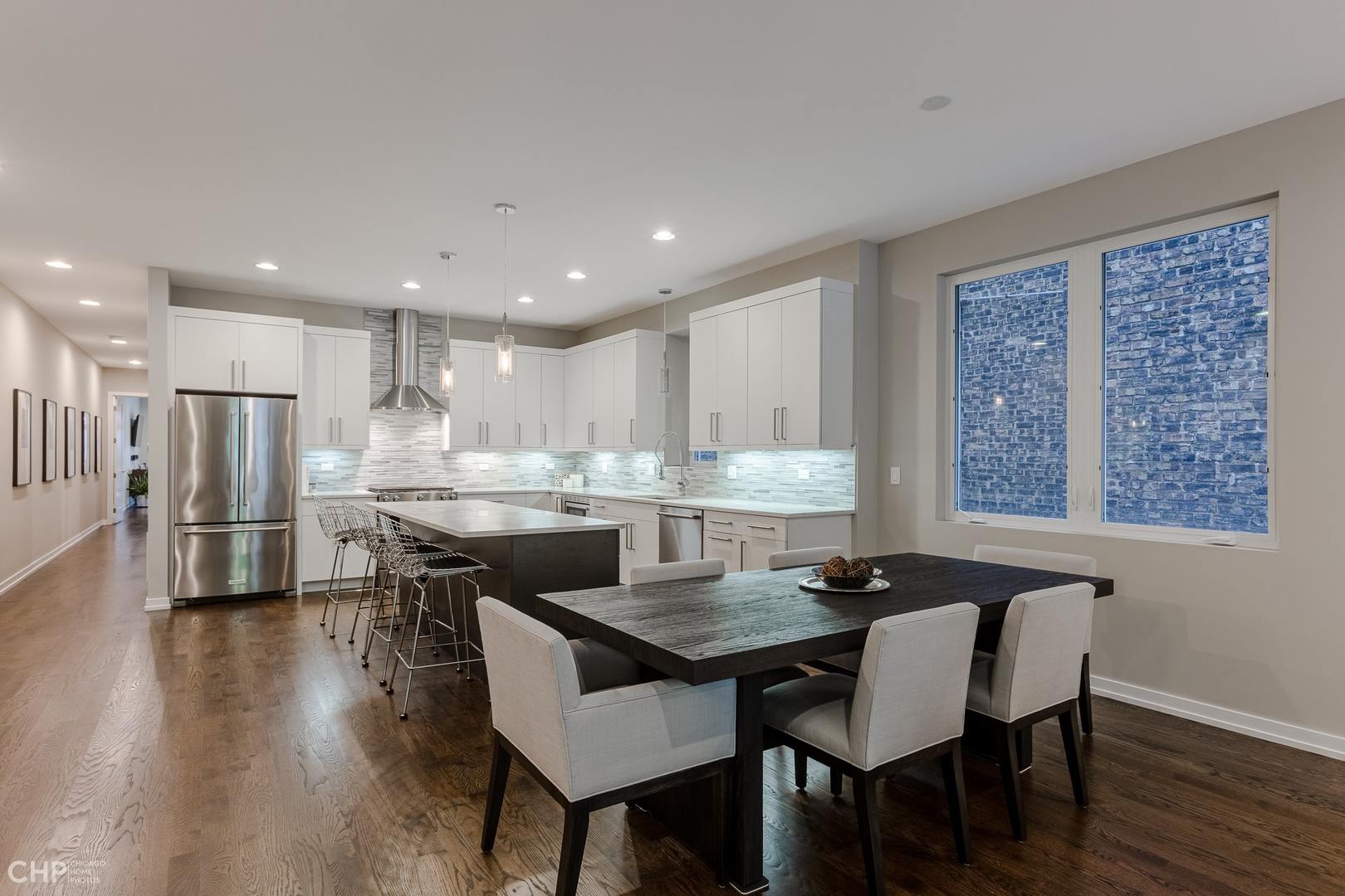 1033 South Racine Avenue, Unit 1S Chicago, IL 60607 - Photo 11 of 32 a kitchen with a dining table chairs and refrigerator