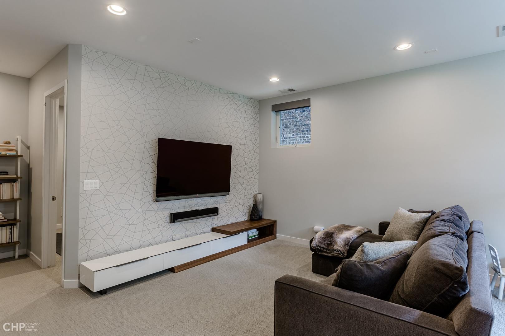 1033 South Racine Avenue, Unit 1S Chicago, IL 60607 - Photo 15 of 32 a living room with furniture and a flat screen tv