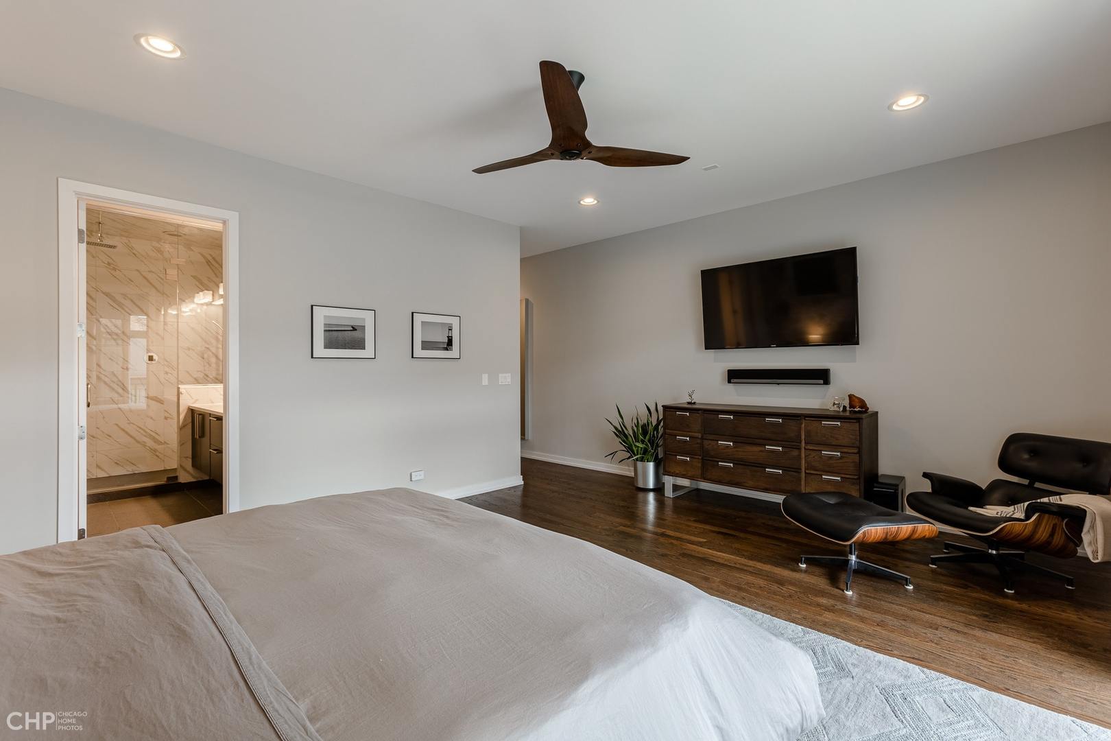 1033 South Racine Avenue, Unit 1S Chicago, IL 60607 - Photo 18 of 32 a bedroom with a bed and a flat screen tv