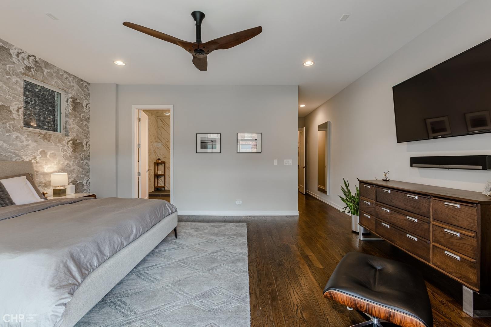 1033 South Racine Avenue, Unit 1S Chicago, IL 60607 - Photo 20 of 32 a bedroom with a bed and a flat screen tv