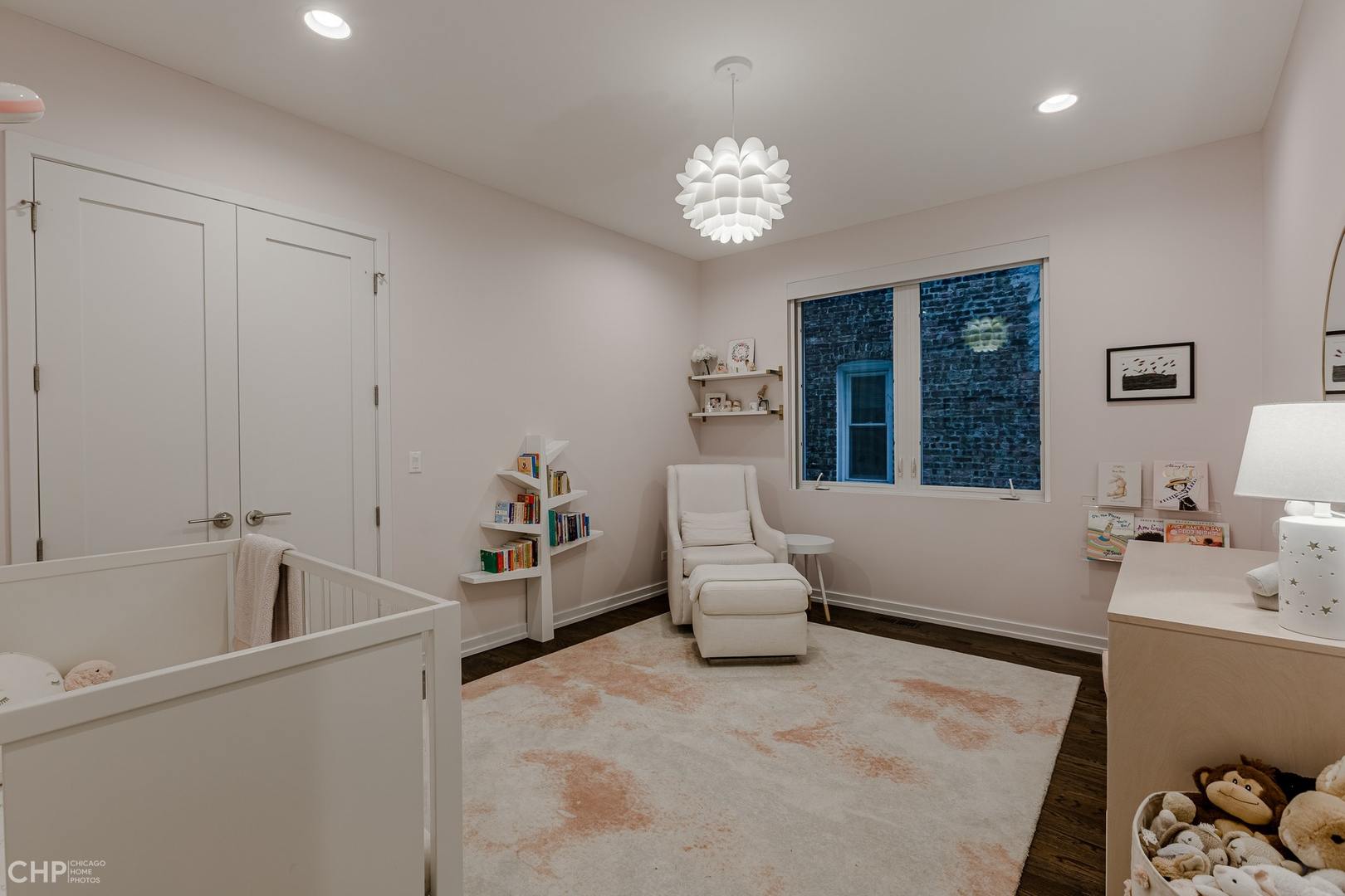 1033 South Racine Avenue, Unit 1S Chicago, IL 60607 - Photo 22 of 32 a spacious bedroom with a bed and a chandelier