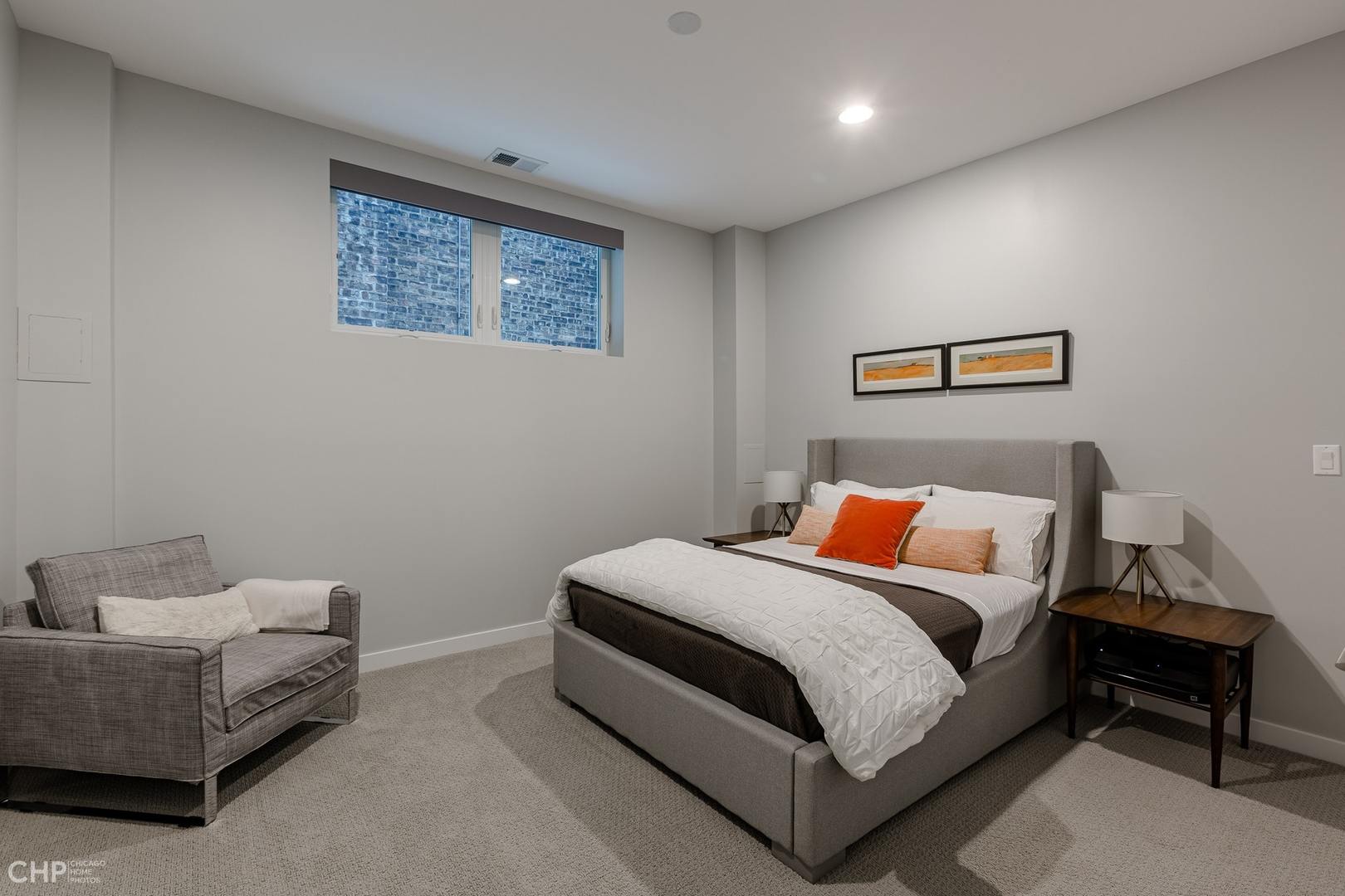 1033 South Racine Avenue, Unit 1S Chicago, IL 60607 - Photo 23 of 32 a bedroom with a bed and a couch