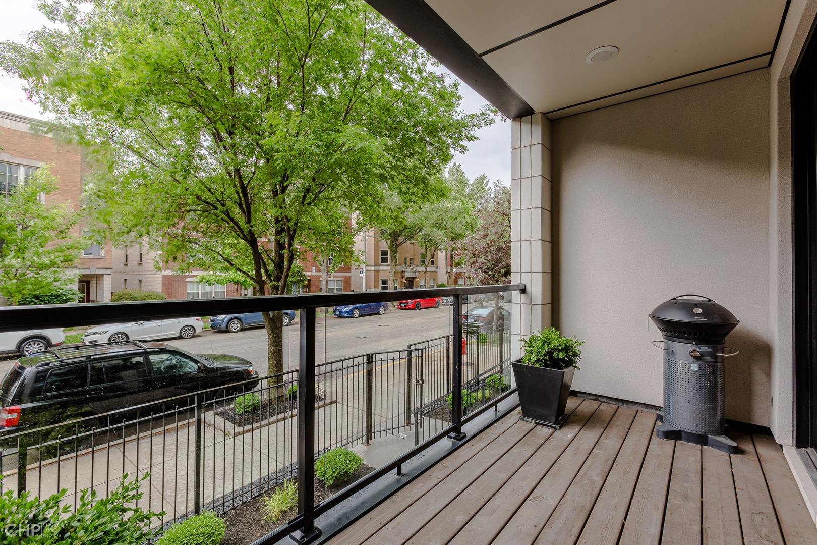 1033 South Racine Avenue, Unit 1S Chicago, IL 60607 - Photo 30 of 32 a view of a balcony with wooden floor