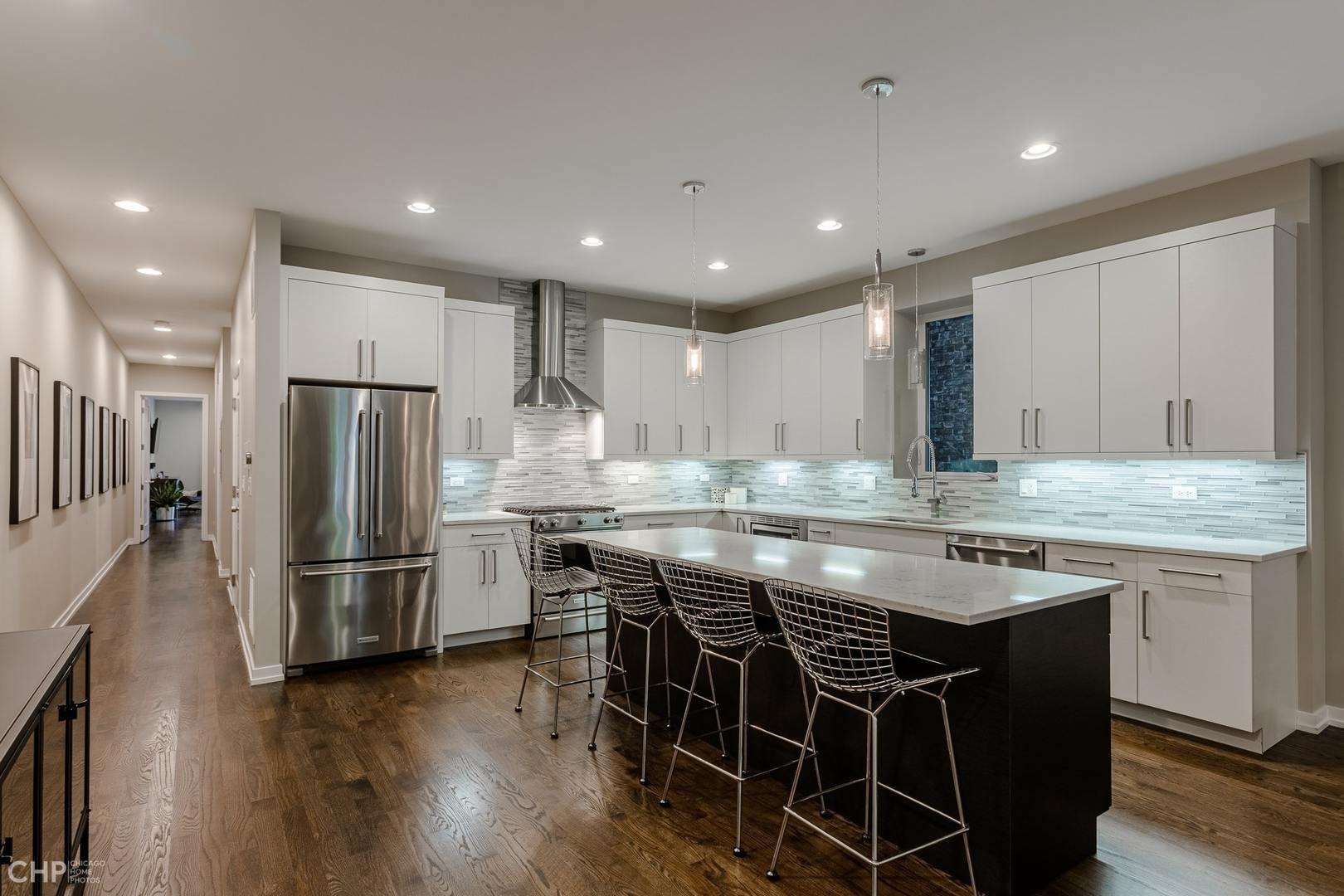 1033 South Racine Avenue, Unit 1S Chicago, IL 60607 - Photo 6 of 32 a kitchen with stainless steel appliances granite countertop a table chairs sink and refrigerator