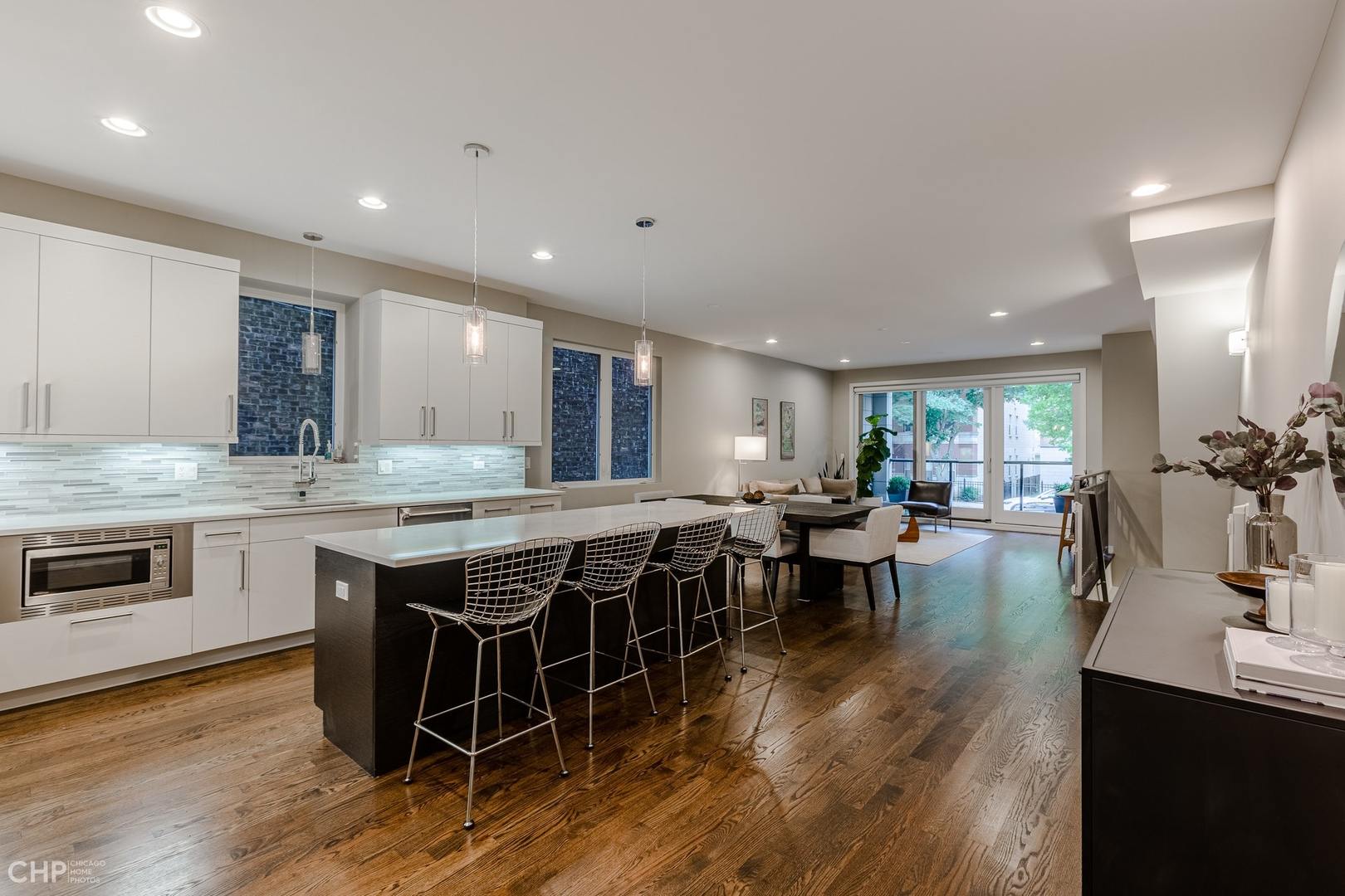 1033 South Racine Avenue, Unit 1S Chicago, IL 60607 - Photo 10 of 32 a large kitchen with kitchen island a sink table and chairs