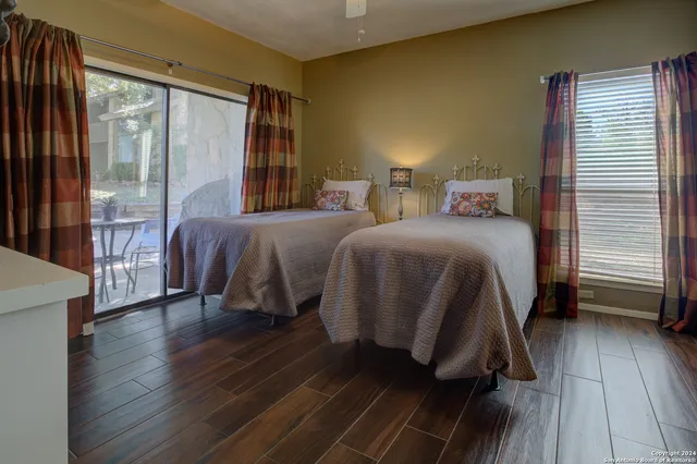 a bedroom with a bed and a large window with outer view