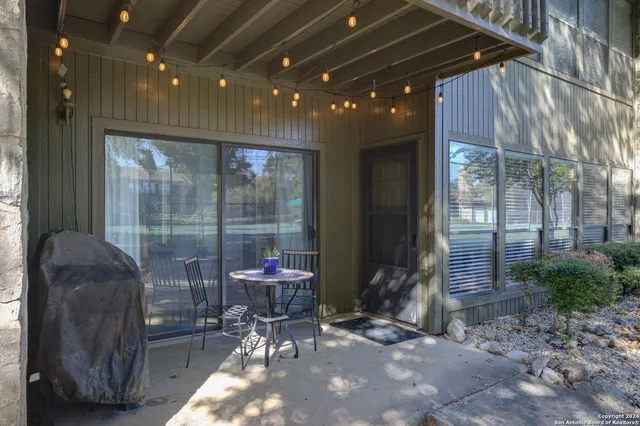 a view of a porch with chairs and potted plants