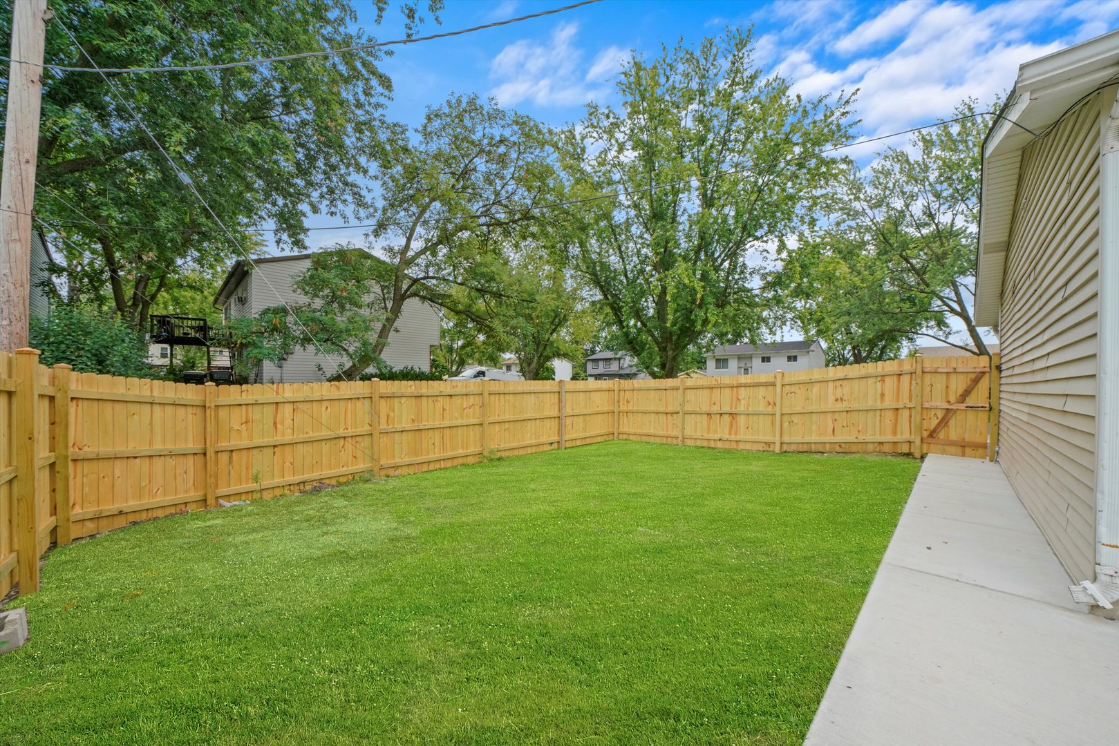 300 Hadleigh Road Bolingbrook, IL 60440 - Photo 37 of 45 a view of a yard with wooden fence