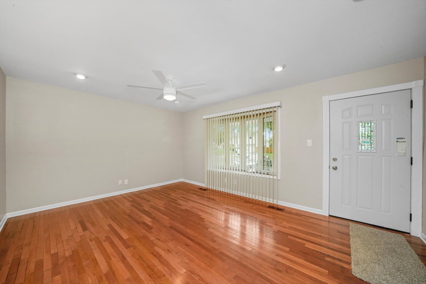 300 Hadleigh Road Bolingbrook, IL 60440 - Photo 4 of 45 an empty room with wooden floor and windows