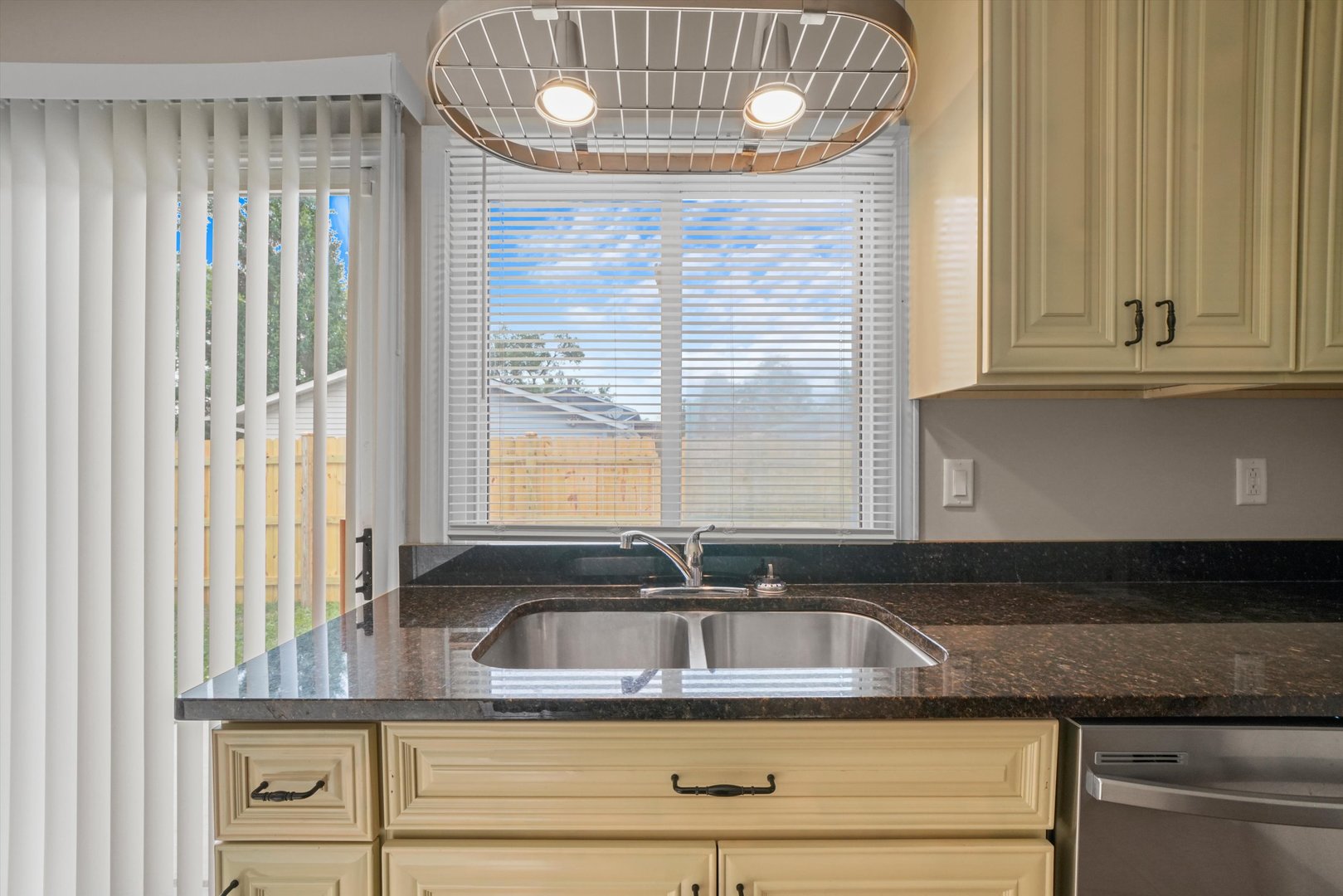 300 Hadleigh Road Bolingbrook, IL 60440 - Photo 9 of 45 a kitchen with granite countertop a sink and a window