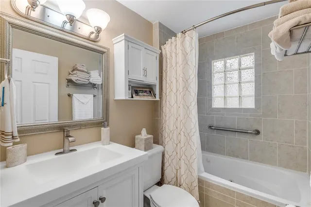 a kitchen with stainless steel appliances a sink cabinets and a refrigerator