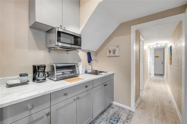 a utility room with wooden floor washer and dryer