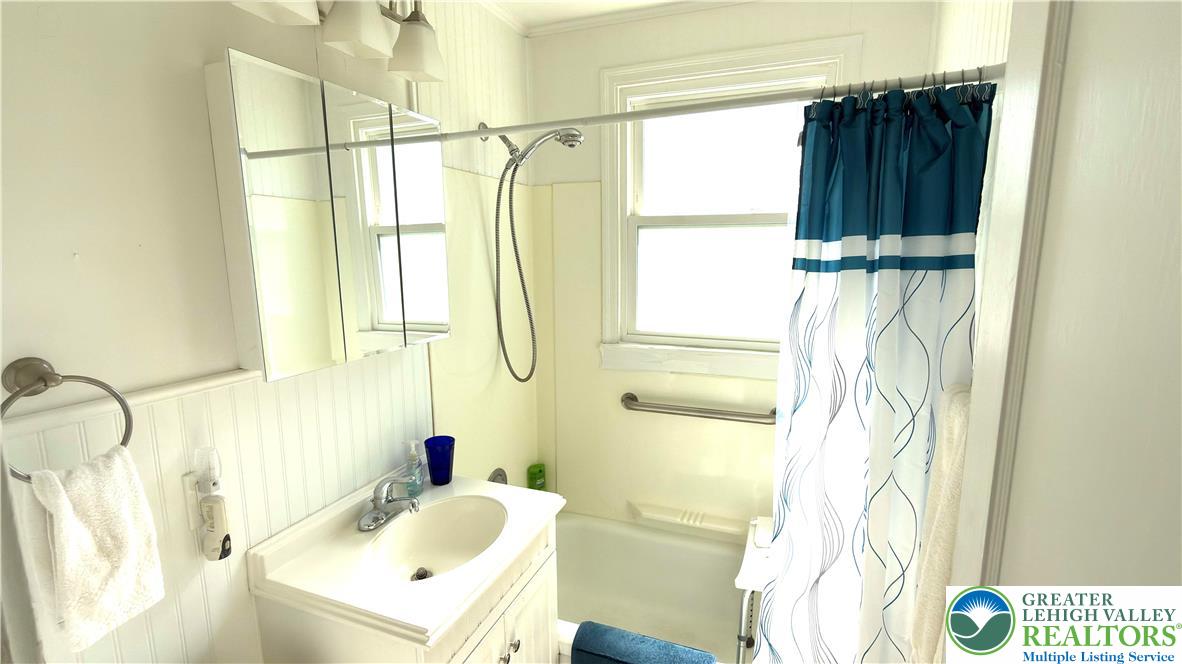 462 Maple Road Hellertown, PA 18055 - Photo 15 of 25 a bathroom with a sink a window and a shower