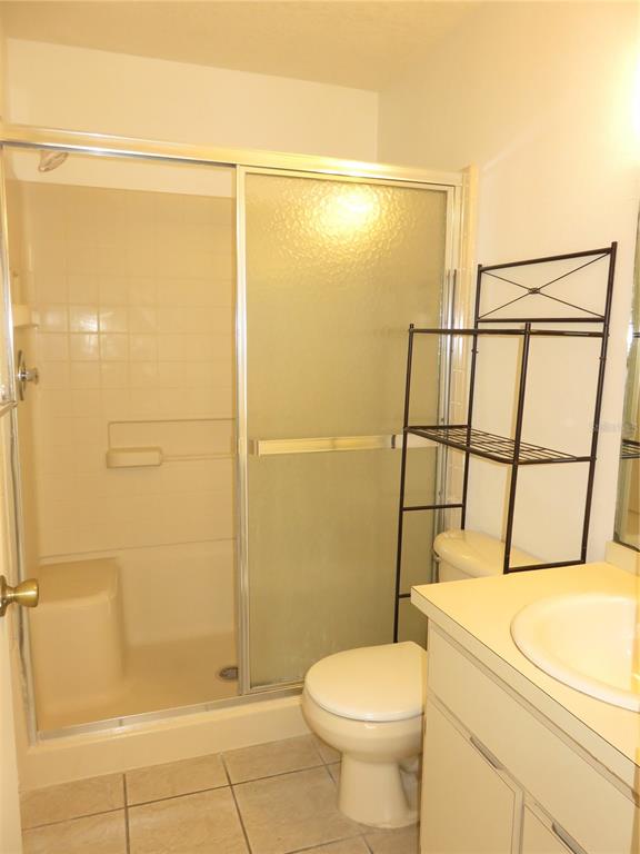 4911 Sunnybrook Drive, Unit 12 New Port Richey, FL 34653 - Photo 16 of 32 a bathroom with a shower and a toilet