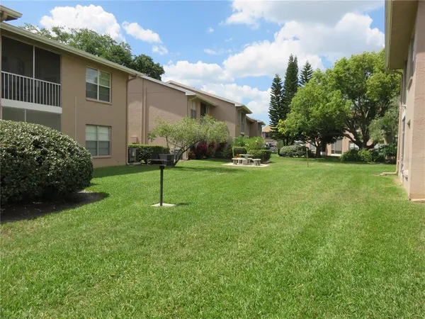 a view of a house with backyard sitting area and garden