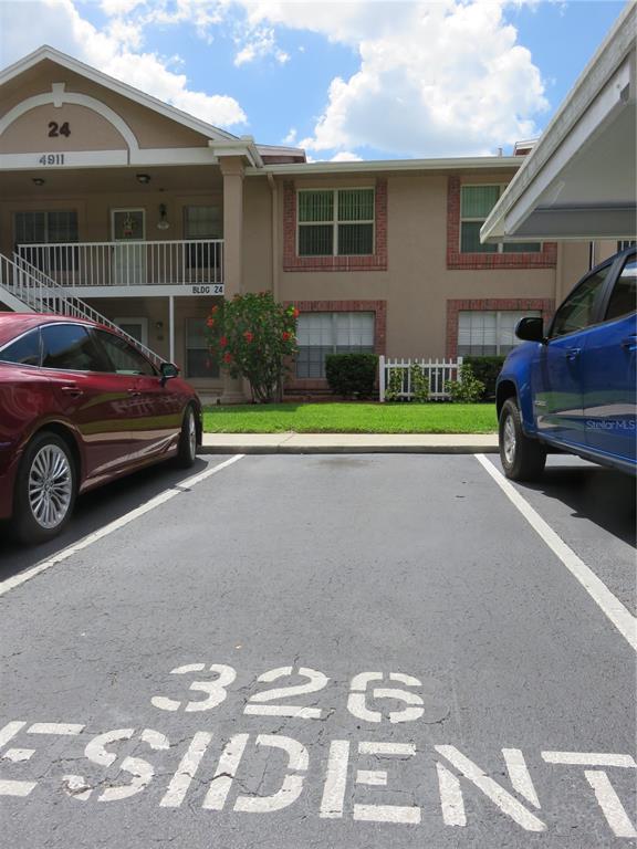 4911 Sunnybrook Drive, Unit 12 New Port Richey, FL 34653 - Photo 21 of 32 a view of a car in front of a house