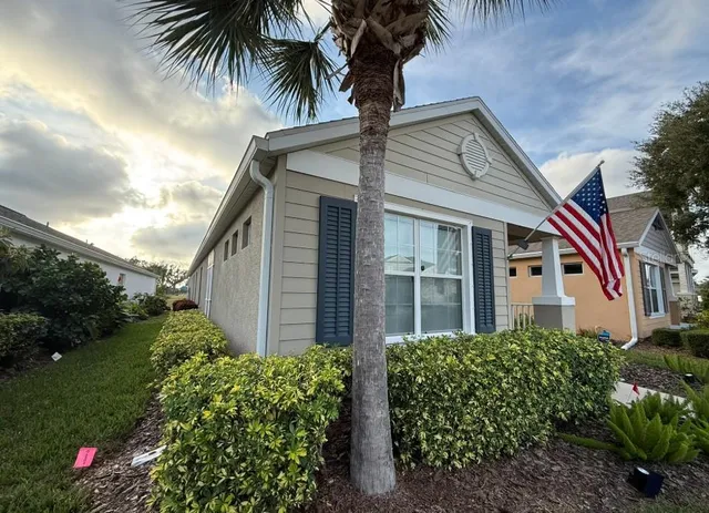 a front view of a house with a garden