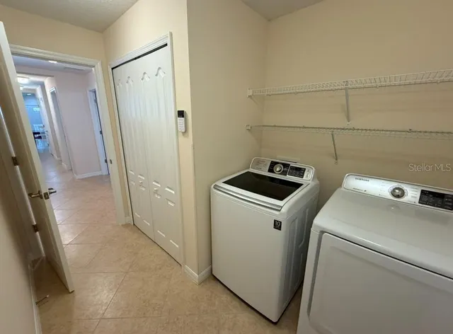 a view of storage and utility room with a washer dryer