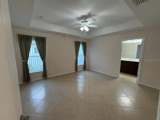 an empty room with windows and entrance