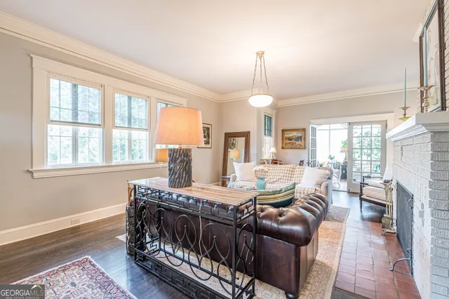 a view of a dining room with furniture large windows and wooden floor