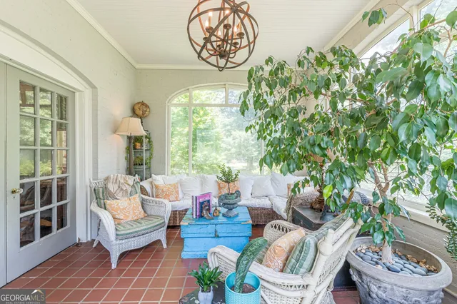 a view of a dining room with furniture a chandelier and wooden floor