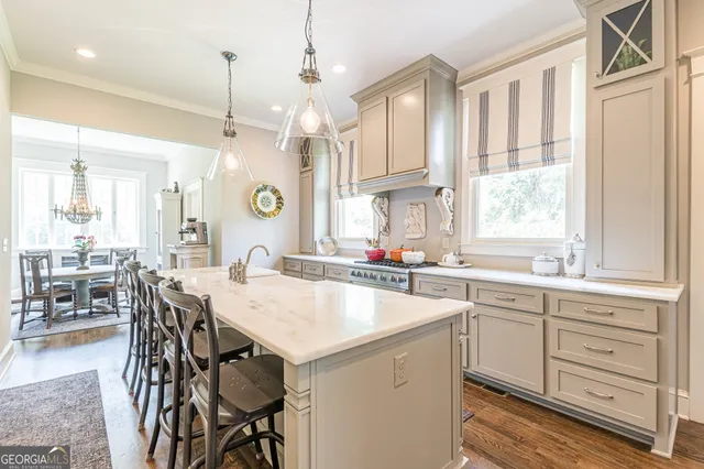 a view of a hallway with wooden floor and stairs