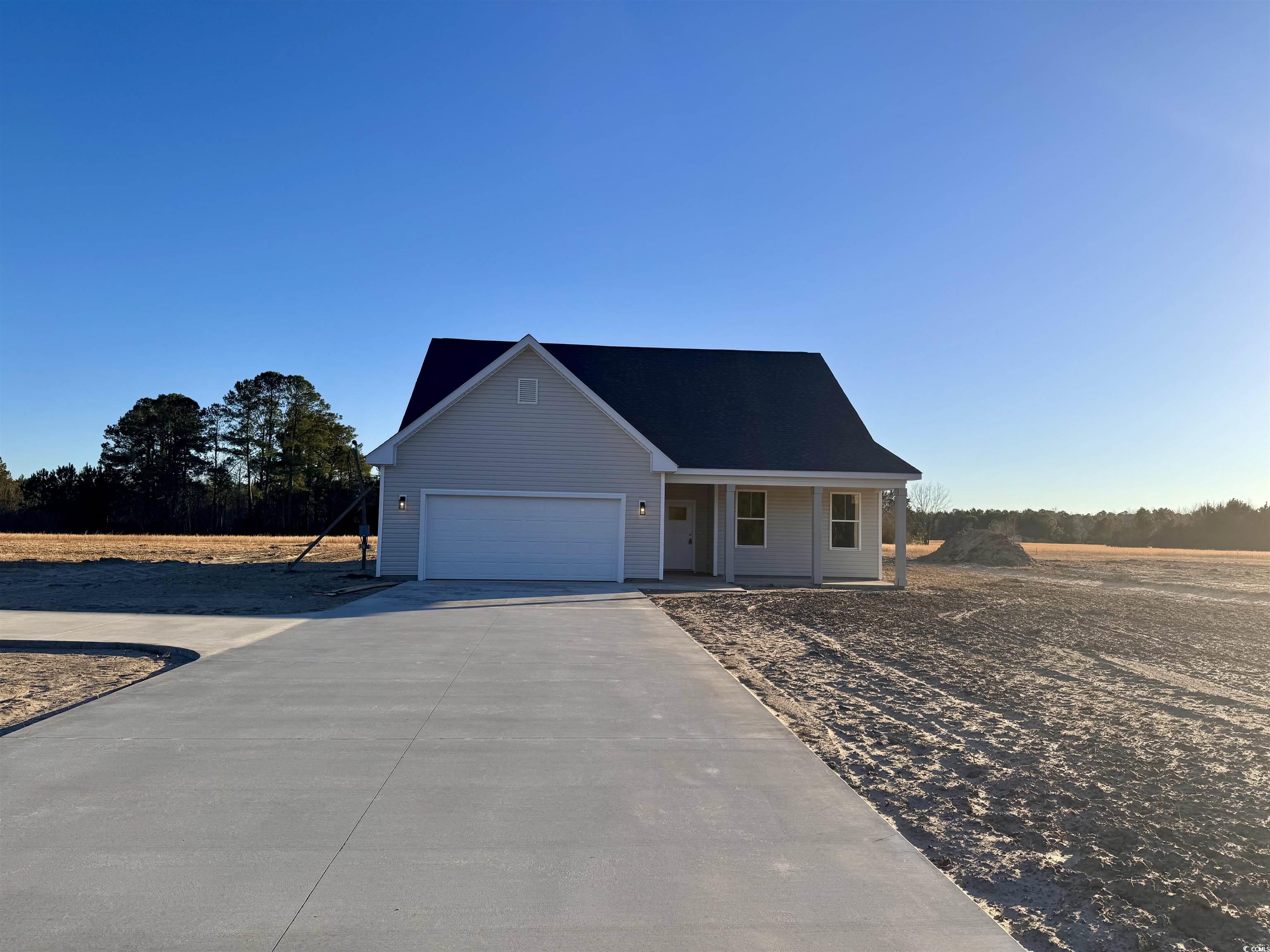 882 Liberty Church Road Loris, SC 29569 - Photo 1 of 22 View of front facade with a porch and a garage