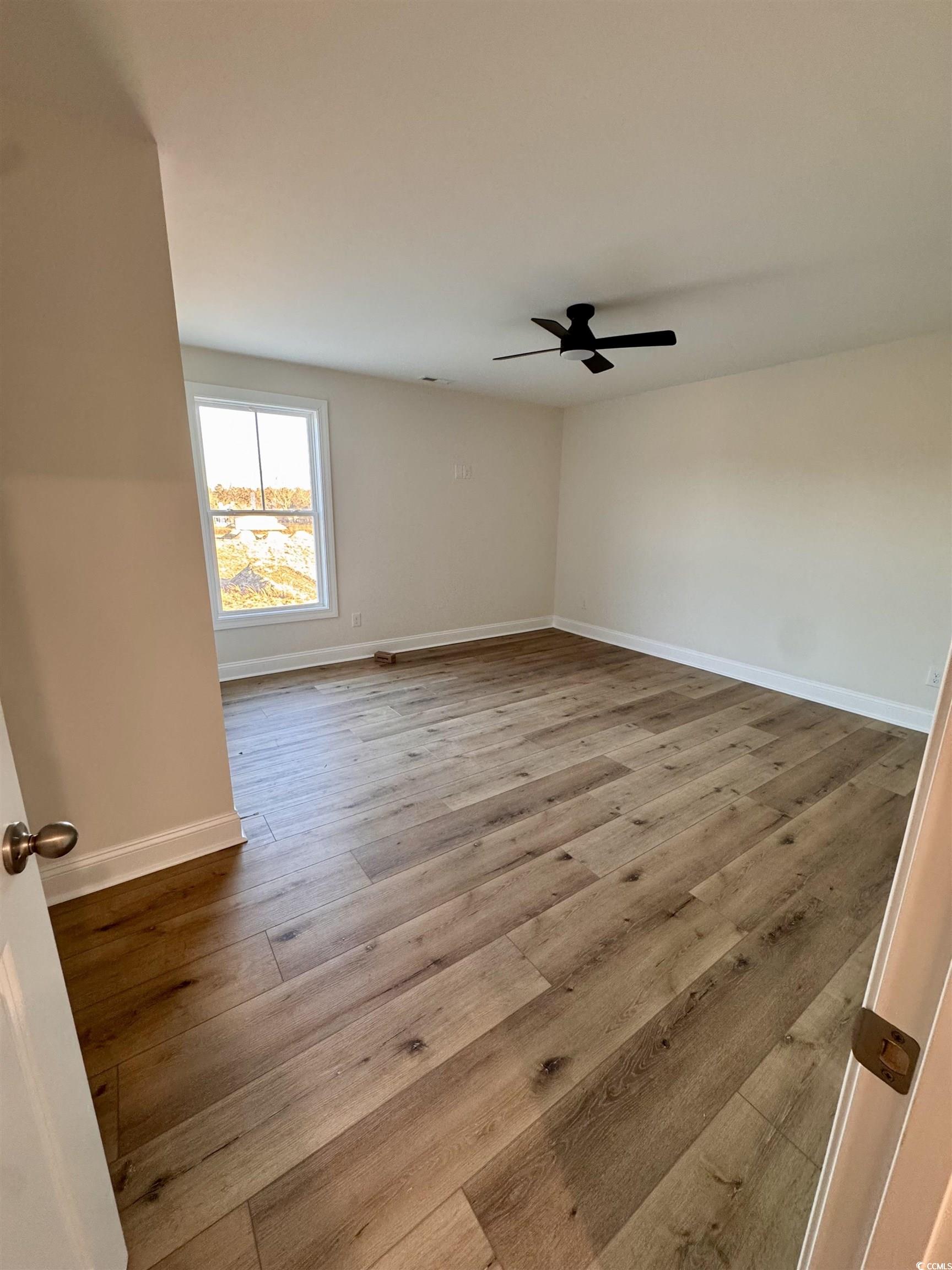 882 Liberty Church Road Loris, SC 29569 - Photo 20 of 22 Empty room with ceiling fan and light hardwood / w