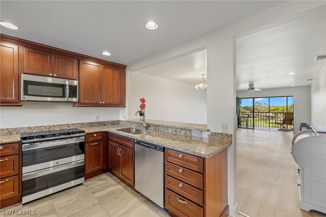 a kitchen with stainless steel appliances granite countertop a sink and stove top oven
