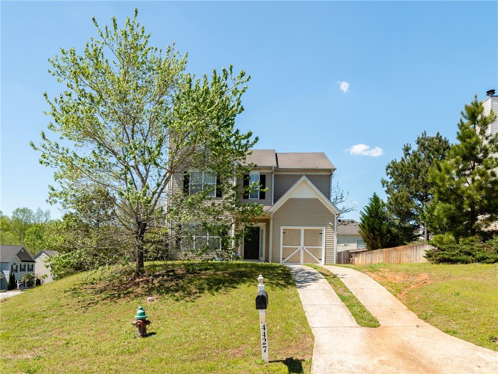 4427 Roche Street Atlanta, GA 30349 - Photo 1 of 1 a front view of a house with a yard