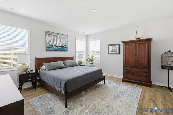 a bedroom with a bed dresser and a window