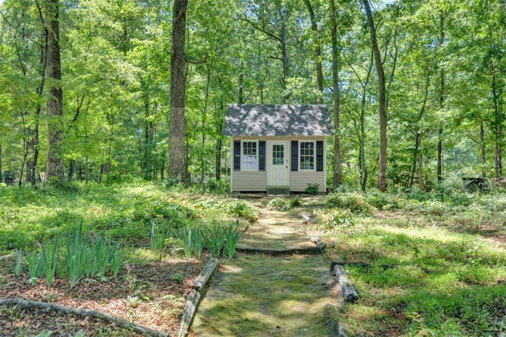 103 Gabriel Way Social Circle, GA 30025 - Photo 60 of 70 a backyard of a house with lots of green space and fountain