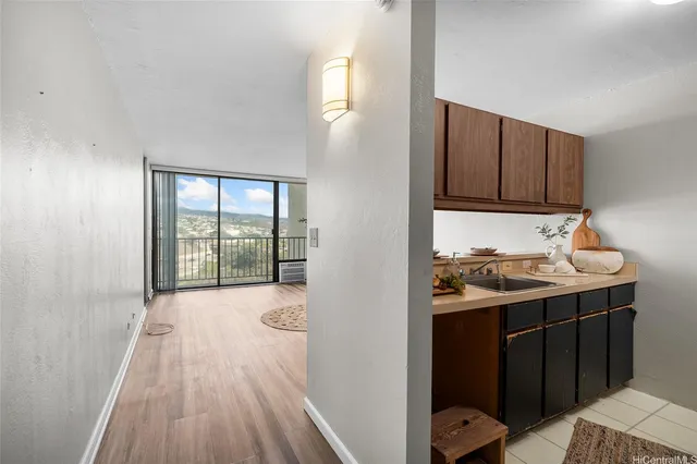 a view of a sink and dishwasher with wooden floor