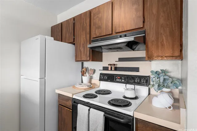 a kitchen with stainless steel appliances a stove a refrigerator and cabinets