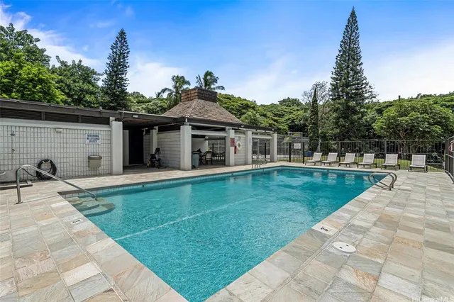 a view of a house with a yard patio and swimming pool