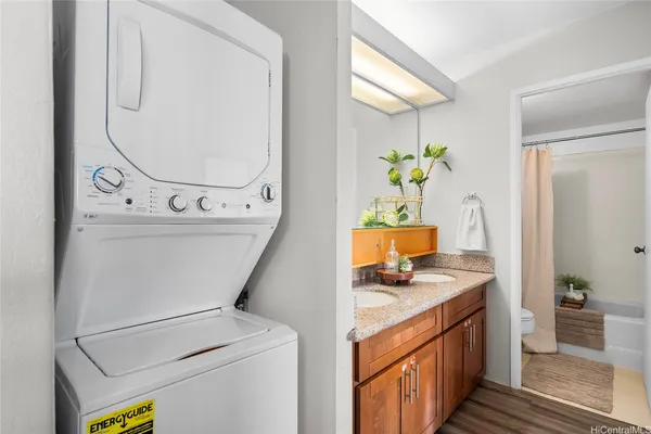 a utility room with cabinets washer and dryer